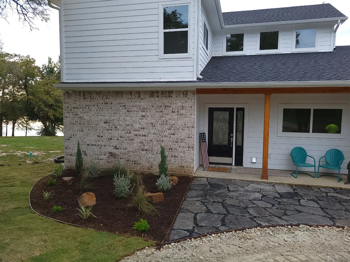 A small concrete patio and a small section designed for a xeriscaping project