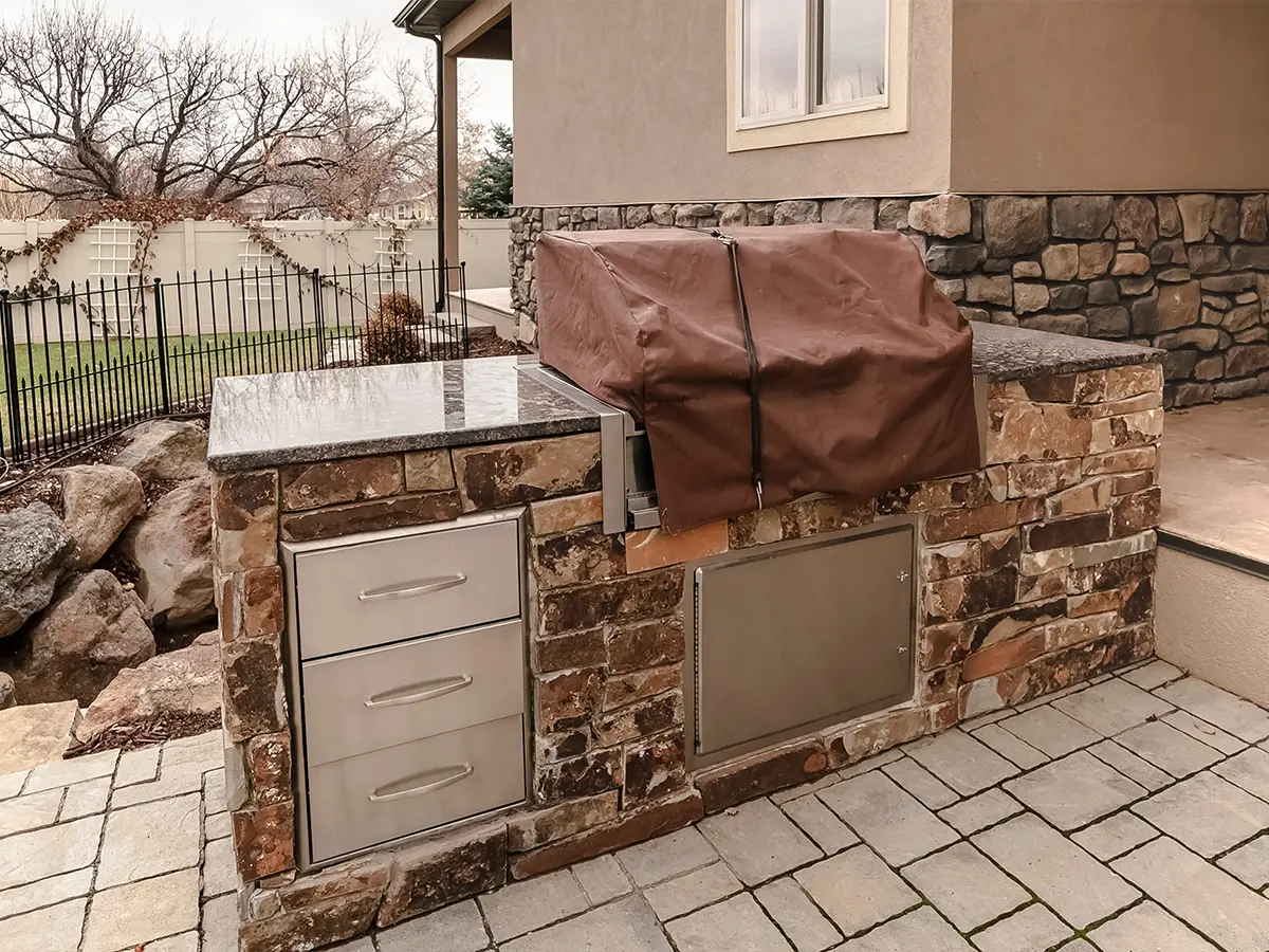 An outdoor kitchen island with brick siding