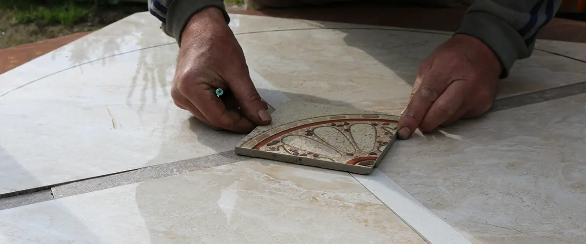 Man placing a mosaic tile.