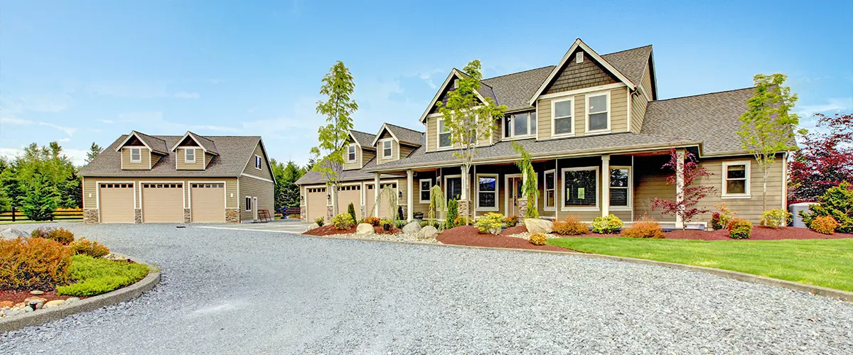 Choosing Between Gravel vs Pebble. Large farm country house with gravel driveway