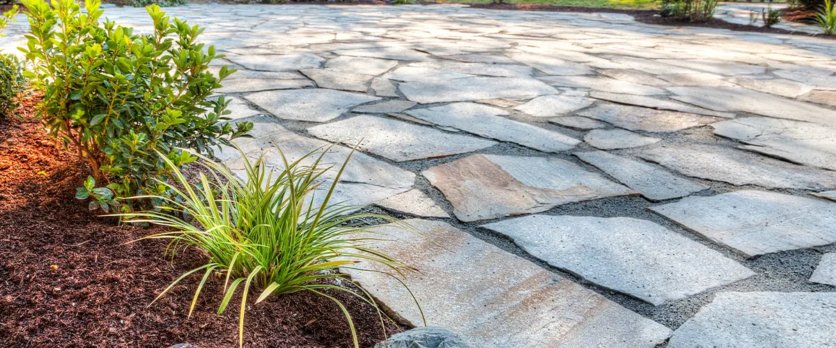 natural stone patio with soil flower edges