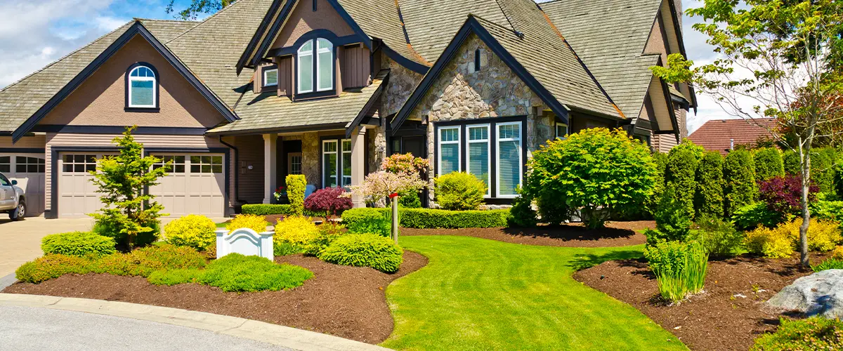 Beautiful suburban home with Beautiful suburban home with manicured lawn, lush landscaping, and stone facade, showcasing residential curb appeal.manicured lawn, lush landscaping, and stone facade, showcasing residential curb appeal.