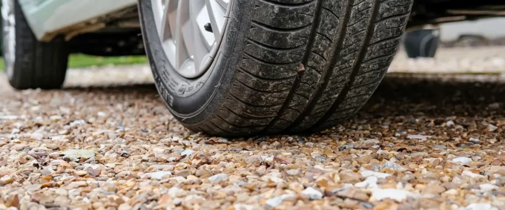 Close-up of car tire on a gravel surface