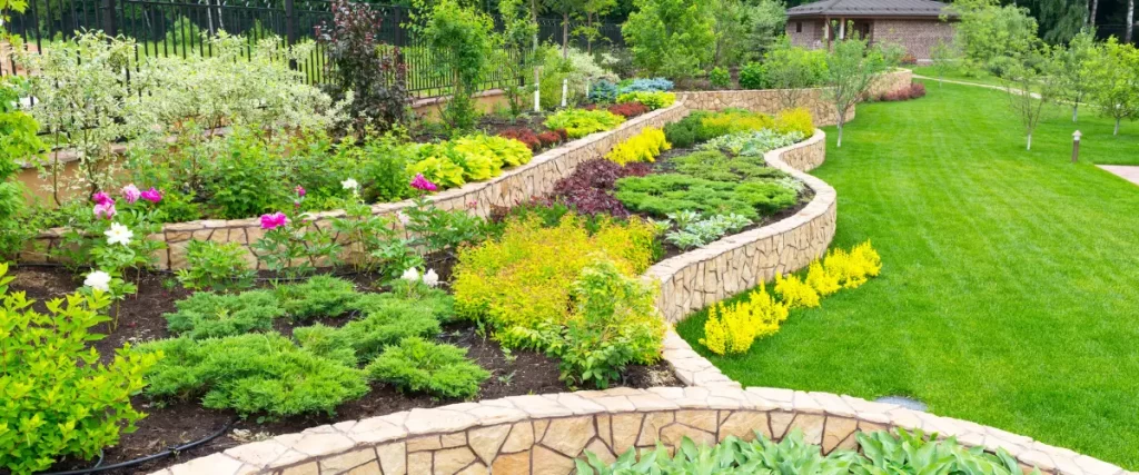 Tiered garden with stone retaining walls and colorful landscaping

