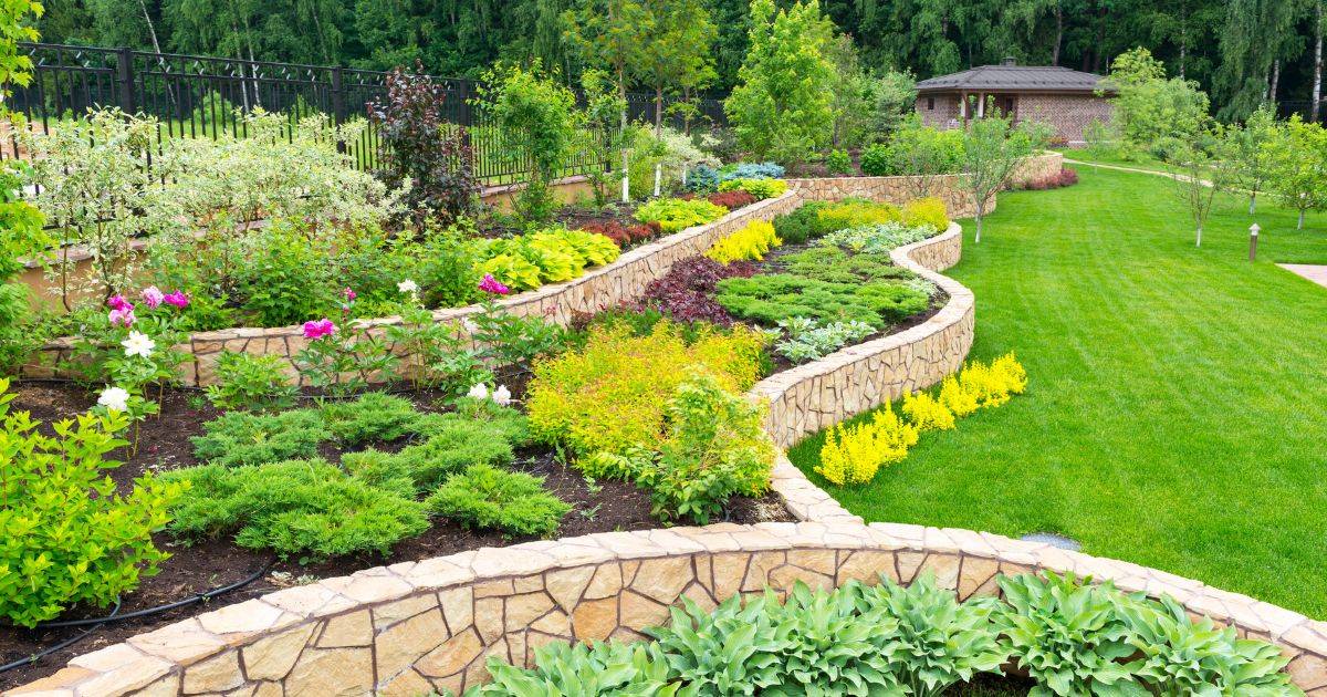 Multi-level landscaped garden with vibrant plants and stone pathways