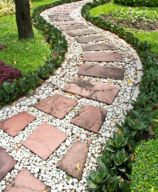 landscaping hardscaping caldwell tx a winding stone pathway with red pavers white pebbles lush greenery